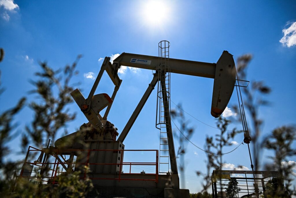 A pumpjack operates at an oil well in Gray Horse, Oklahoma, on September 29, 2023. - As eagles swoop overhead and a cool autumnal wind blows through the cemetery in Gray Horse, on the ancient lands of the Osage people in northern Oklahoma, Margie Burkhart points to the tombs of ancestors murdered a century ago. The tragedy that struck her family is at the heart of the new Martin Scorsese film "Killers of the Flower Moon," taken from the best-selling book of the same name. (Photo by CHANDAN KHANNA / AFP)