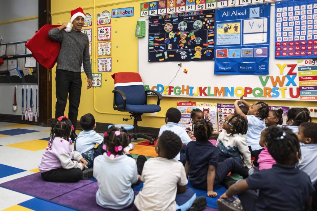 Former President Barack Obama makes a surprise visit to a pre-kindergarten class at Parkside Community Academy in South Shore, Chicago, Tuesday, Dec. 12, 2023. (Ashlee Rezin/Chicago Sun-Times via AP, Pool)